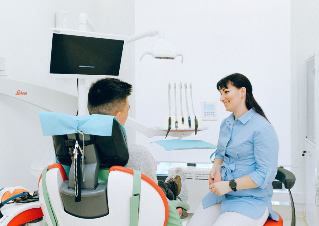 Orthodontist discussing braces costs and insurance coverage with a patient during a consultation.