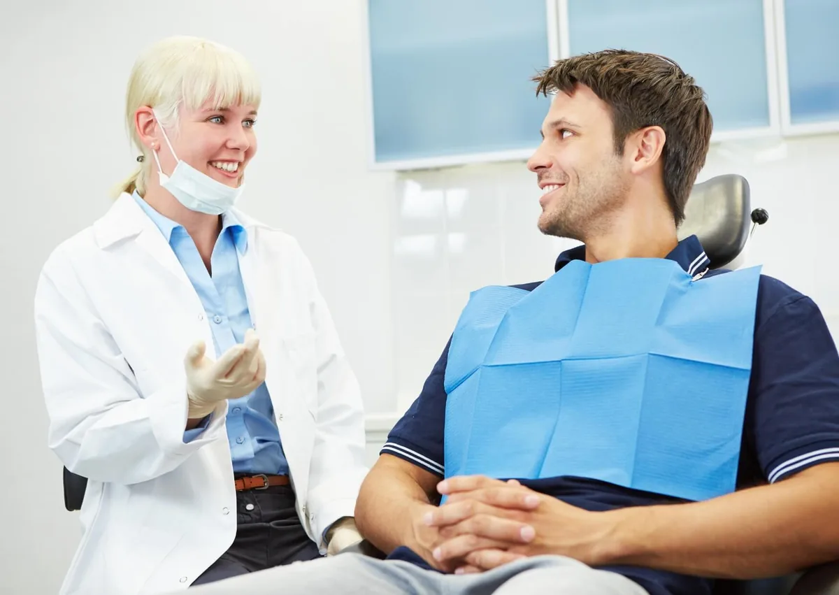 Dental professional discussing dental bonding cost and cosmetic treatment options with a patient.