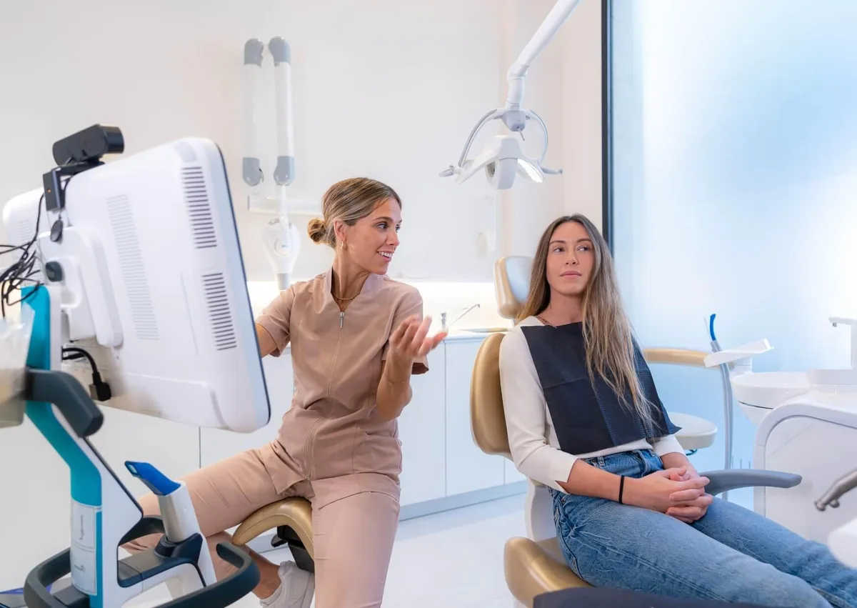 Dental professional discussing smile makeover options and expected results with a patient.
